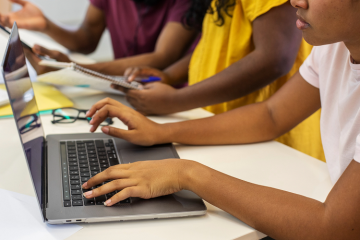 Image of three children working on a computer
